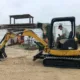 Operator using CAT 303E mini excavator at a Williams Diesel LLC job site in Seattle, showcasing CAT 303E mini excavator details and performance.