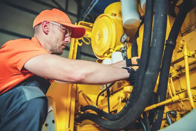A heavy equipment maintenance & servicing expert doing his work at Williams Diesel LLC's site in Seattle.