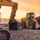 Heavy construction equipment on a job site at sunset representing diesel repair and rental Washington services offered for project efficiency and uptime.
