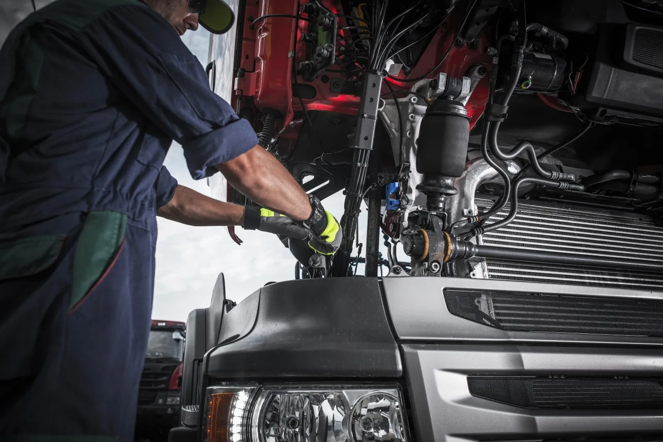 Technician performing diesel truck repair services on a heavy-duty vehicle in Seattle, ensuring engine performance and safety.