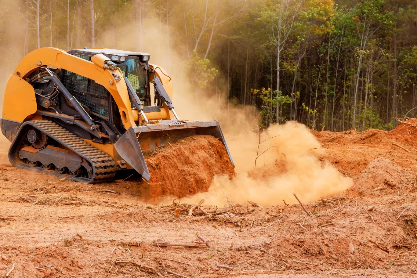 Cat track loader efficiently moving soil on a construction site, showcasing the power and performance of a Cat track loader rental in Seattle.