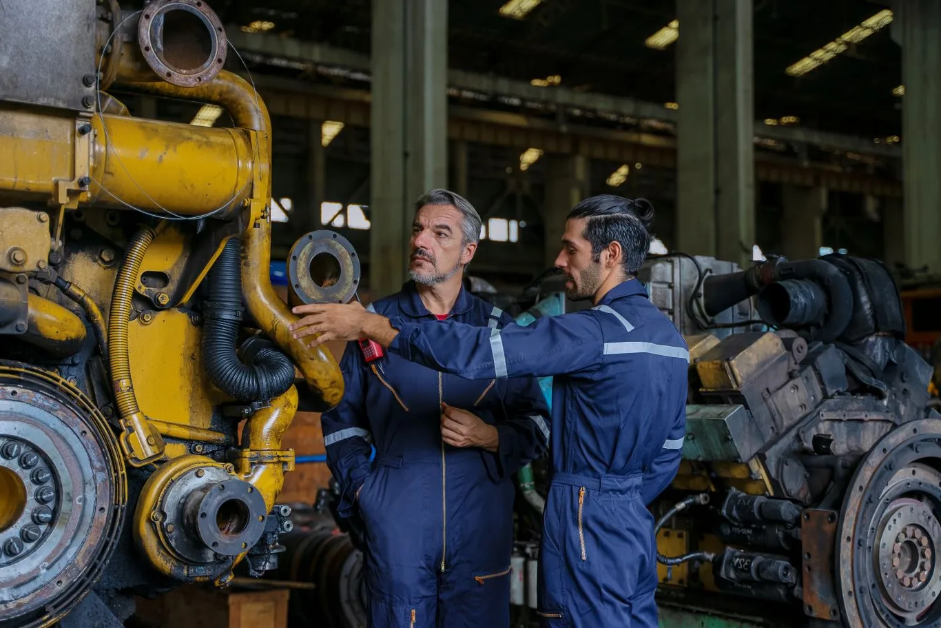Experienced mechanics working on a heavy-duty engine inside a diesel repair shop in Seattle, providing expert diesel auto repair and maintenance services.