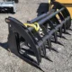 Heavy-duty brush grapple attachment for skid steer, available for rental in Seattle, ideal for land clearing, log handling, and debris removal.