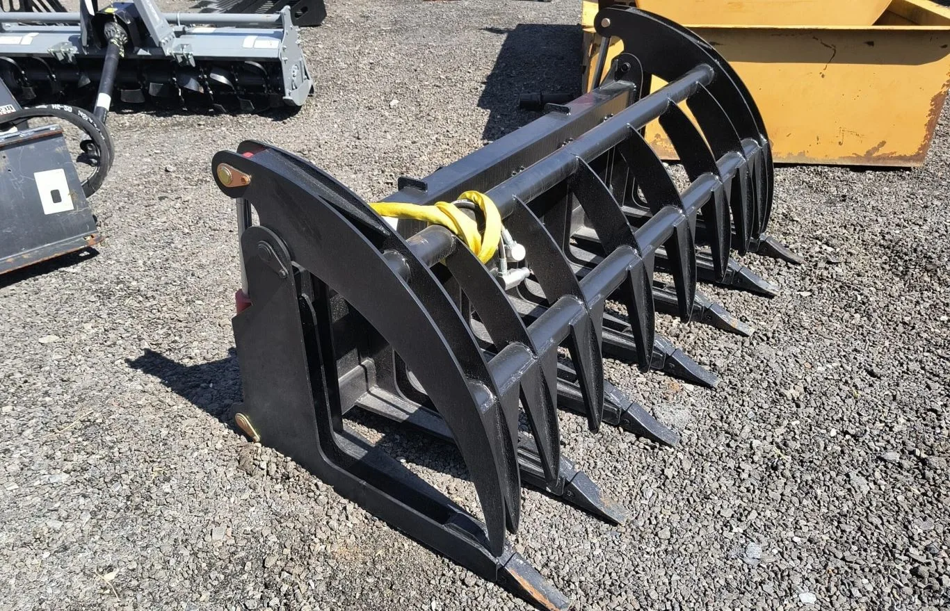 Heavy-duty brush grapple attachment for skid steer, available for rental in Seattle, ideal for land clearing, log handling, and debris removal.