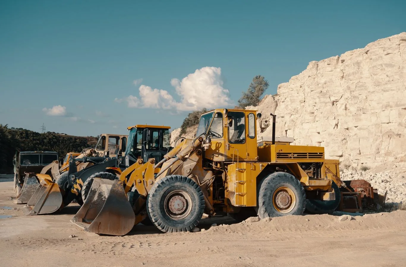 Heavy construction loaders parked at a worksite, showcasing affordable equipment rental in Seattle for contractors and construction projects.