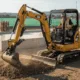 A construction worker operating a compact CAT excavator on a job site, representing professional and reliable excavator rental in Seattle for residential and commercial projects.