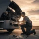 A mechanic performing mobile diesel repair on a truck engine at sunset, showing on-site roadside service and professional diesel maintenance in Seattle, Washington.