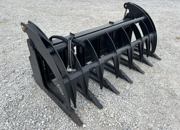 A heavy-duty log grapple attachment used for land clearing projects