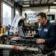 A skilled technician from Williams Diesel LLC performing diagnostics on a truck engine inside a workshop, showcasing expert commercial equipment rental maintenance and diesel repair services.