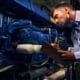Technician inspecting a diesel engine and recording notes, demonstrating how diesel machine works to improve equipment performance and reliability.