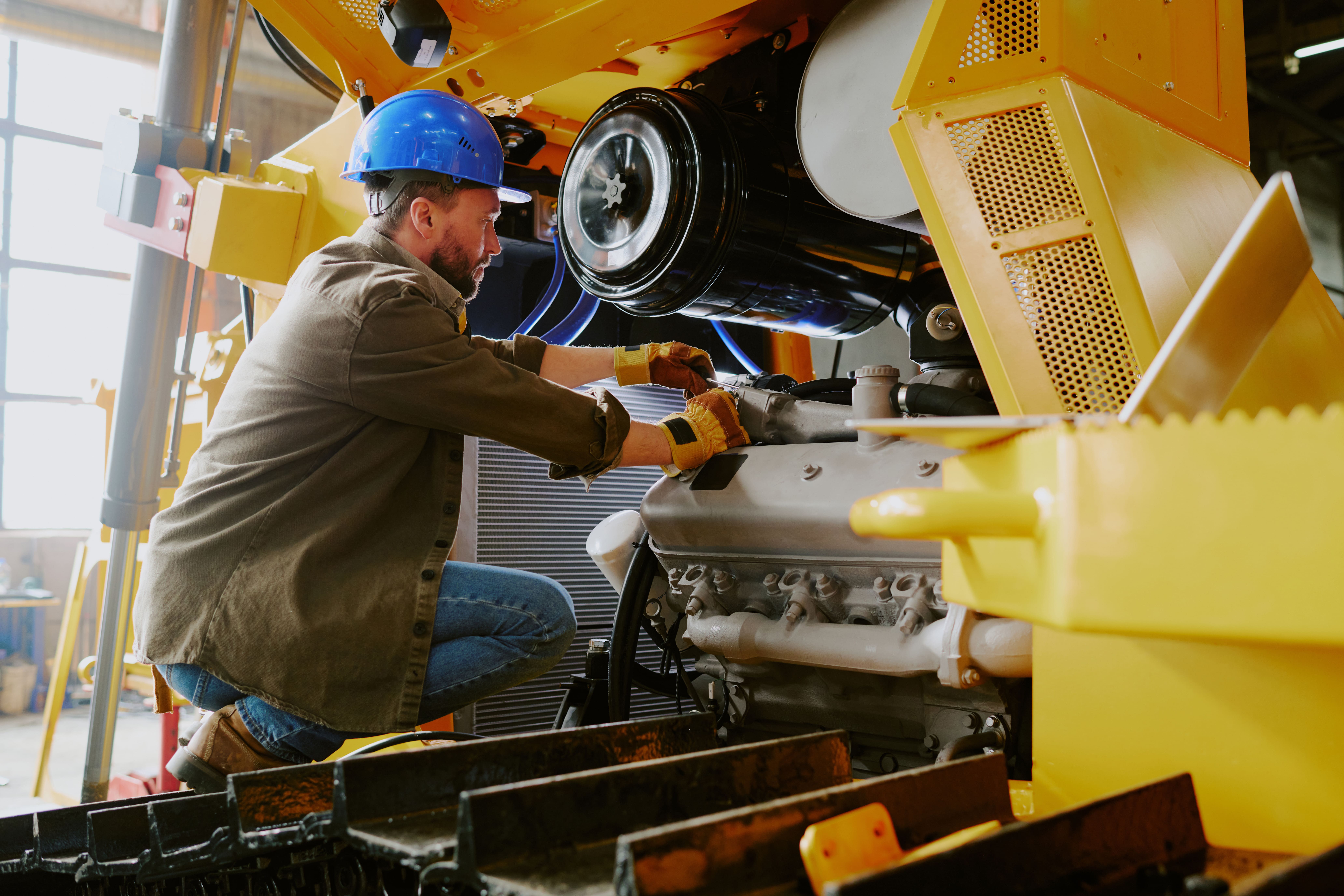 A professional diesel mechanic Seattle inspecting a heavy-duty truck engine.