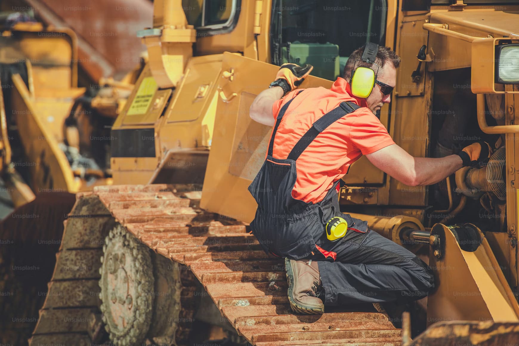 A professional technician from Williams Diesel LLC performing an advanced roadside service on a heavy-duty commercial truck parked on a safety-marked shoulder.