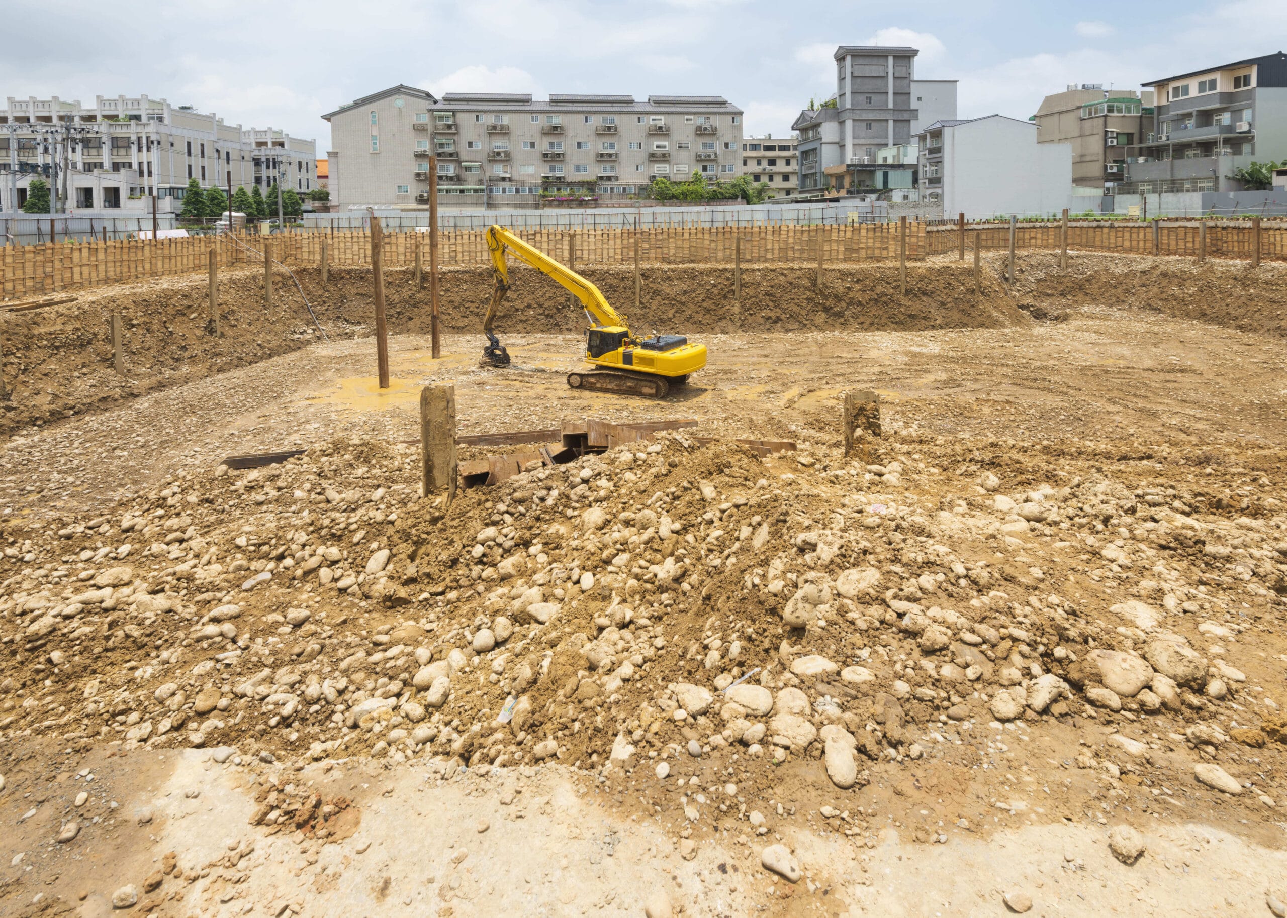 A professional-grade gasoline-powered wacker plate, equipped with a resilient black urethane Poly Pad attachment, resting on a freshly swept decorative concrete paver patio surface, ready for the final setting pass.