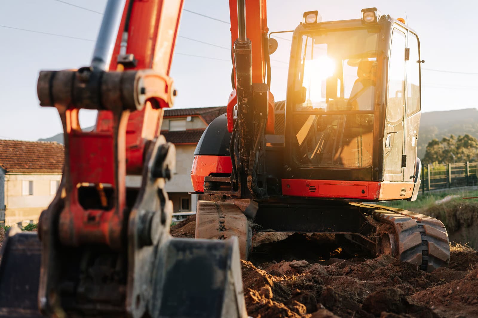 A line of pristine, mechanic-certified excavators for hire parked neatly on a commercial earthmoving construction site, ready for immediate field deployment.