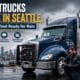 A heavy-duty commercial vehicle receiving professional diesel trucks service from a technician during a rainy day in Seattle, Washington.